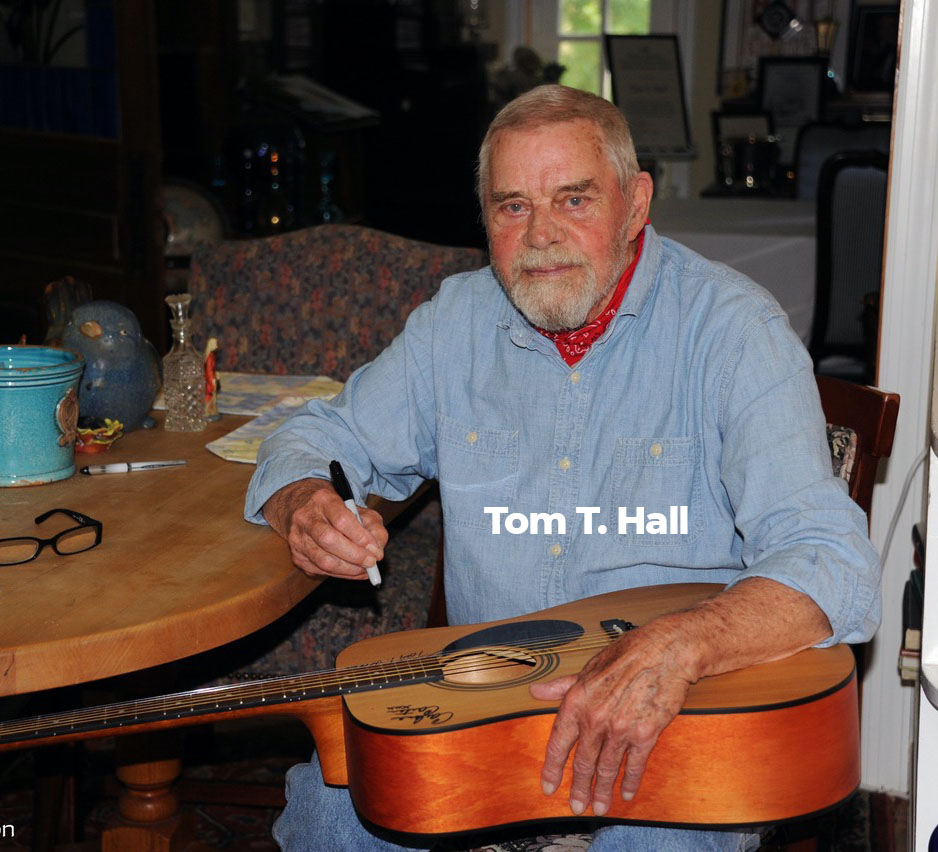 Country Musician Tom T. Hall Signing A Guitar For A Carter Fold Raffle